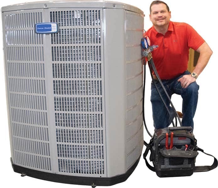 Vanderford Air and Plumbing technician measuring static pressure at an attic air handler during AC maintenance in Clear Lake, TX.